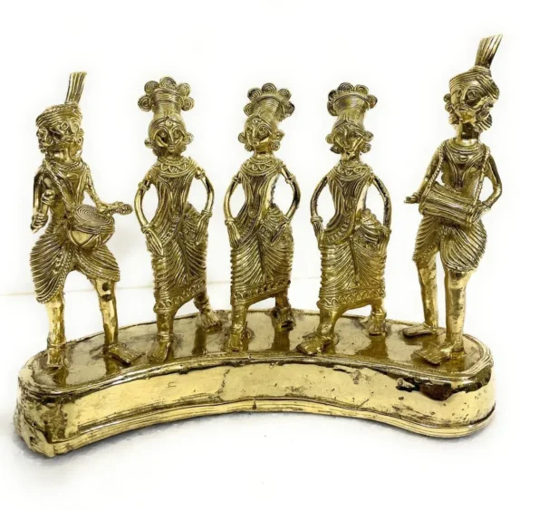 Five intricately crafted brass tribal figurines stand on a curved base, each holding musical instruments and dressed in traditional attire, representing a folk music ensemble.