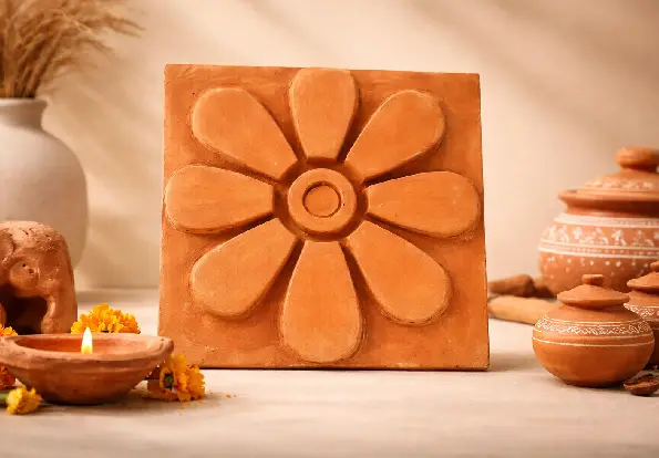 Decorative terracotta flower tile displayed with rustic clay décor inspired by authentic Terracotta Handicrafts.